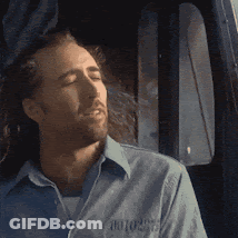 A Man Wearing A Blue Shirt With The Word Motors On The Front GIF