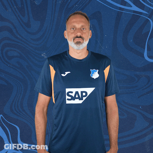 A Man Wearing A Blue Shirt With The Word Sap On The Front GIF