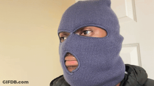 A Man Wearing A Blue Ski Mask With A Hole In The Middle Of His Face GIF