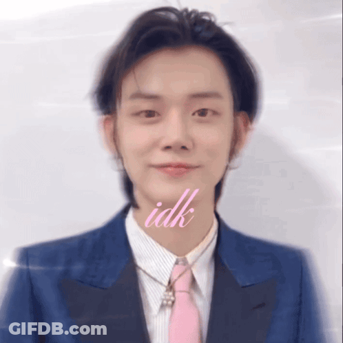 A Man Wearing A Blue Suit And A Pink Tie Has The Word Idk Above His Mouth GIF
