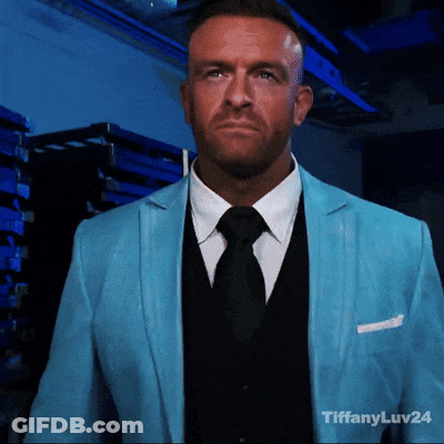 A Man Wearing A Blue Suit And Black Tie With Tiffanyluv24 In The Corner GIF