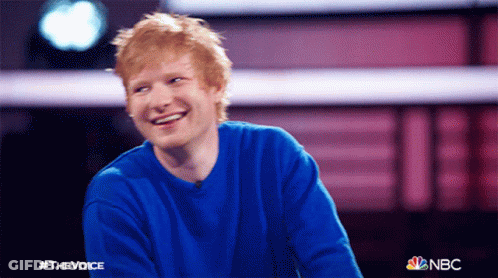 A Man Wearing A Blue Sweater Is Smiling For A Photo That Says #Thevoice On It GIF