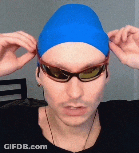 A Man Wearing A Blue Swim Cap And Sunglasses Adjusts His Sunglasses GIF