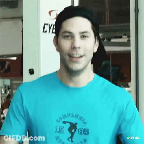 A Man Wearing A Blue T-Shirt That Says Companions 1985 GIF