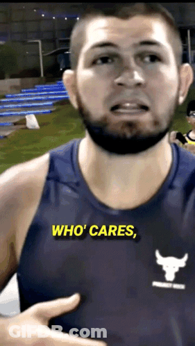 A Man Wearing A Blue Tank Top That Says Who Cares On It GIF