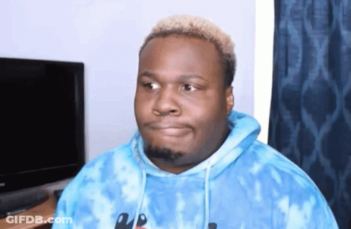 A Man Wearing A Blue Tie Dye Hoodie Looks To The Side GIF