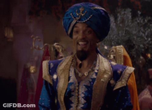 A Man Wearing A Blue Turban And A Blue And Gold Outfit Is Smiling GIF