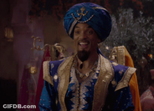 A Man Wearing A Blue Turban And A Blue And Gold Outfit Is Smiling GIF