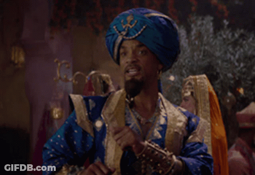 A Man Wearing A Blue Turban Is Talking On A Cell Phone GIF