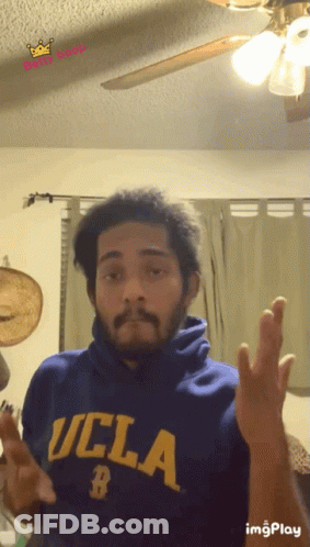 A Man Wearing A Blue Ucla Sweatshirt Makes A Funny Face GIF