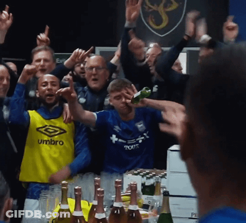 A Man Wearing A Blue Umbro Jersey Stands In Front Of A Crowd GIF