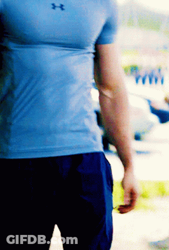 A Man Wearing A Blue Under Armour Shirt And Blue Shorts GIF