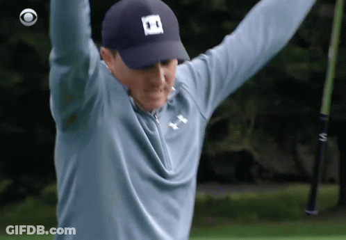 A Man Wearing A Blue Under Armour Shirt Is Holding A Golf Club In His Hands GIF