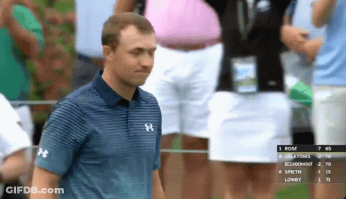 A Man Wearing A Blue Under Armour Shirt Stands In Front Of A Scoreboard GIF