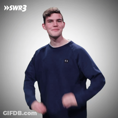 A Man Wearing A Blue Under Armour Sweatshirt Is Dancing In Front Of A Swr3 Logo GIF