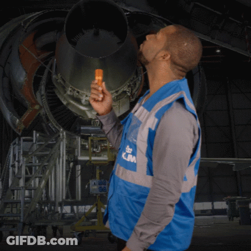 A Man Wearing A Blue Vest That Says Klm On The Front GIF