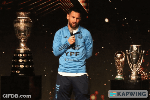 A Man Wearing A Blue Ypf Shirt Stands In Front Of A Microphone GIF