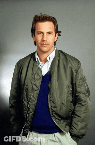 A Man Wearing A Bomber Jacket And A Blue Sweater GIF