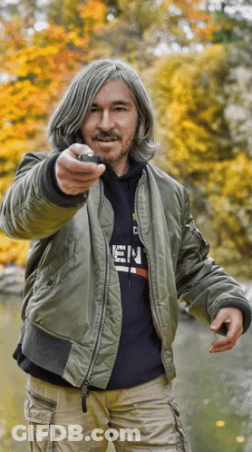 A Man Wearing A Bomber Jacket And A Hoodie That Says ' E.n. ' On It GIF