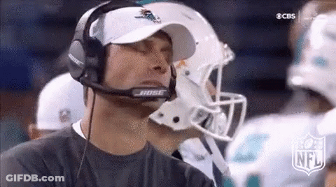 A Man Wearing A Bose Headset Is Watching A Football Game On Cbs . GIF