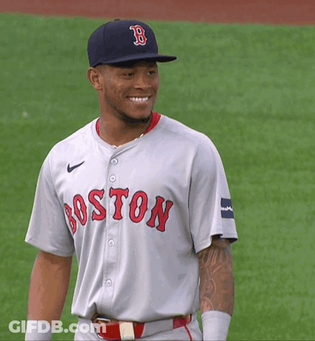 A Man Wearing A Boston Jersey And A Hat Smiles GIF