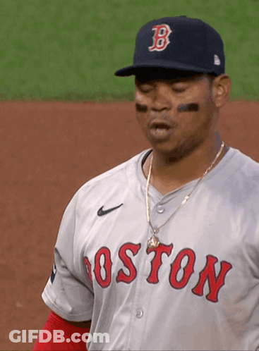 A Man Wearing A Boston Jersey And A Hat With The Letter B On It GIF