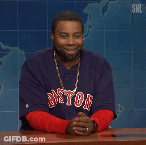 A Man Wearing A Boston Jersey Is Sitting At A Desk GIF