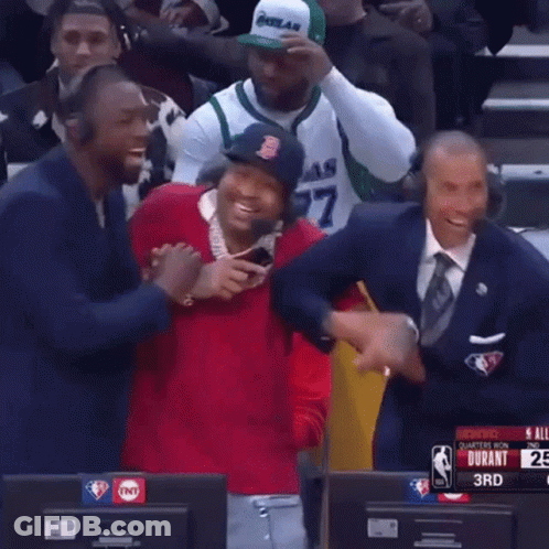 A Man Wearing A Boston Red Sox Hat Is Laughing While Sitting In Front Of A Tnt Sign GIF