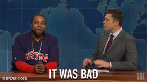 A Man Wearing A Boston Red Sox Shirt Is Sitting Next To A Man In A Suit GIF