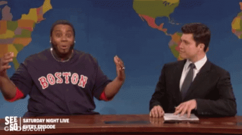 A Man Wearing A Boston Shirt Points Up At Something GIF