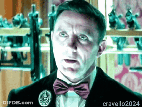 A Man Wearing A Bow Tie And A Pin With The Name Cravello2024 GIF