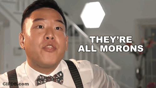 A Man Wearing A Bow Tie And Suspenders Says " They 'Re All Morons " GIF