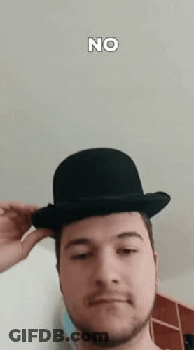 A Man Wearing A Bowler Hat With The Word No On The Bottom Right GIF