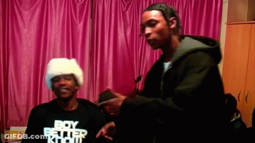 A Man Wearing A Boy Better Know T-Shirt Stands Next To Another Man GIF