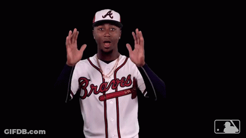 A Man Wearing A Braves Jersey Is Making A Funny Face GIF