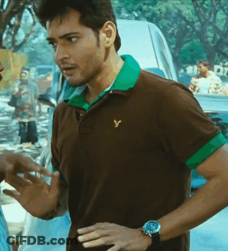 A Man Wearing A Brown And Green Polo Shirt With A Yellow Eagle On It GIF
