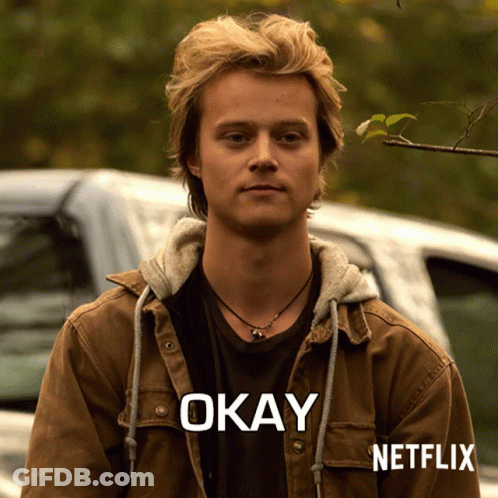 A Man Wearing A Brown Jacket With The Word Okay Written On It GIF