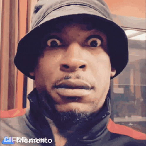 A Man Wearing A Bucket Hat And A Momento Logo On The Bottom GIF