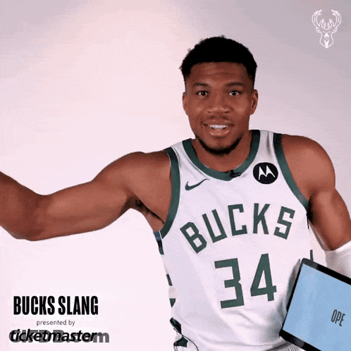 A Man Wearing A Bucks Jersey Holds A Tablet GIF