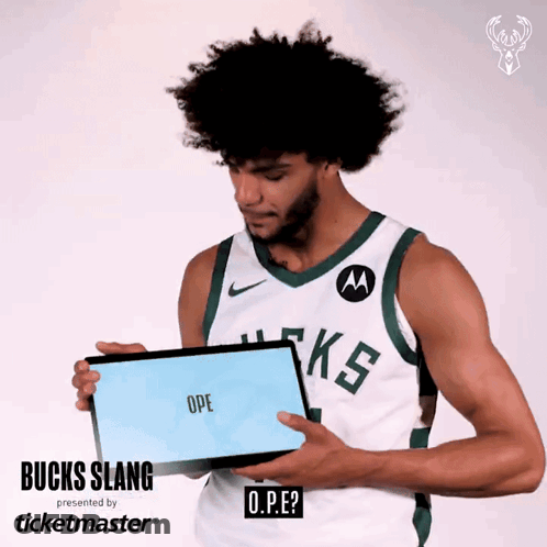 A Man Wearing A Bucks Jersey Is Holding A Sign That Says Ope GIF