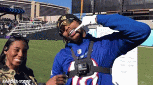 A Man Wearing A Buffalo Bills Jersey Is Giving A Thumbs Up Sign GIF