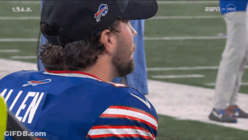 A Man Wearing A Buffalo Bills Jersey Looks To The Side GIF