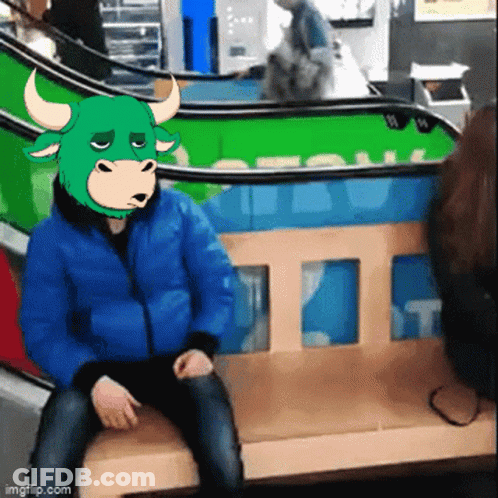 Man In Bull Mask Sitting On Bench GIF
