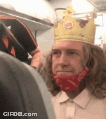 A Man Wearing A Burger King Crown And A Red Face Mask GIF