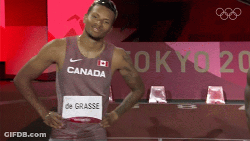 A Man Wearing A Canada Jersey Is Standing In Front Of A Tokyo 2020 Sign GIF