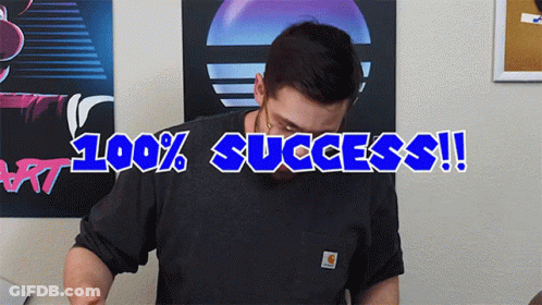 A Man Wearing A Carhartt Shirt Stands In Front Of A Poster That Says 100 % Success GIF
