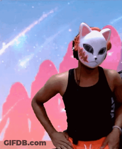 A Man Wearing A Cat Mask And Headphones Is Standing With His Hands On His Hips GIF