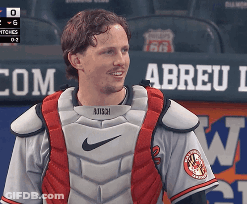 A Man Wearing A Catcher 'S Vest That Says Rutsch GIF