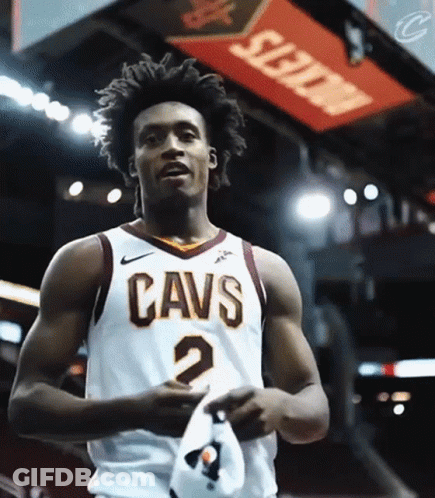 A Man Wearing A Cavs Jersey Holds A Hat GIF