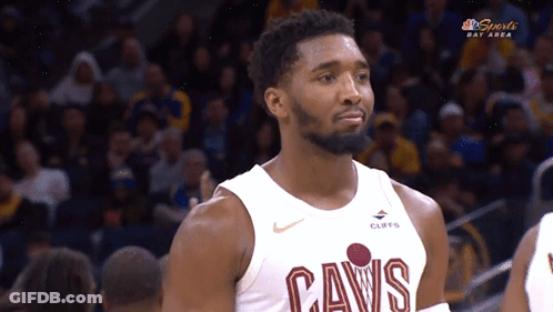 A Man Wearing A Cavs Jersey Looks At Something GIF
